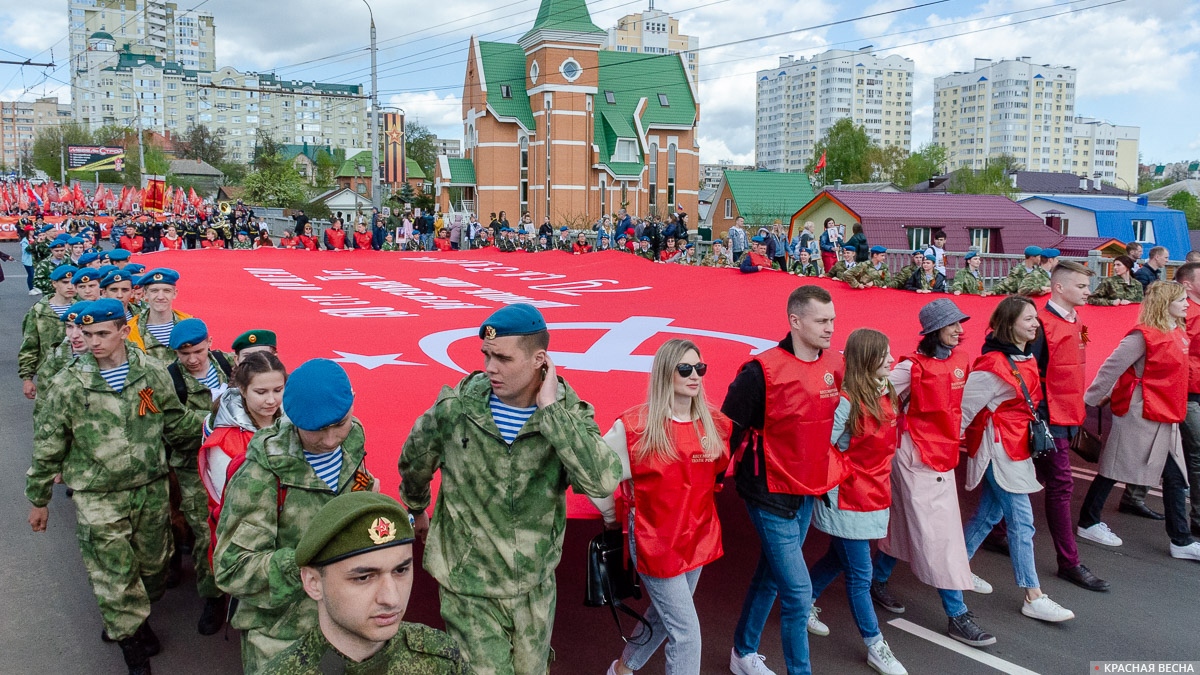 Двадцати-метровое Знамя Победы несут перед колонной 